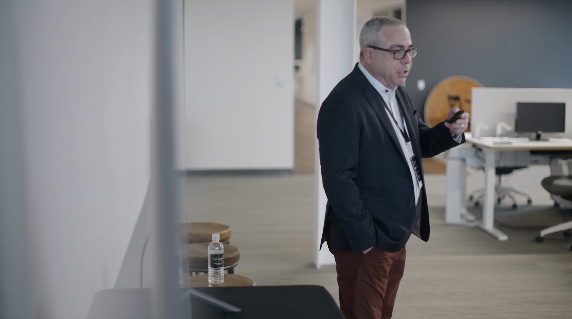 Image of person presenting in front of a small crowd